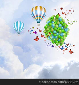 Holiday background. Sunny image with balloons and aerostat flying in blue sky