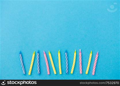 holiday, celebration and party concept - birthday candles on blue background. birthday candles on blue background