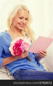 holiday, celebration, home and birthday concept - smiling young woman with greeting card and bouquet of flowers