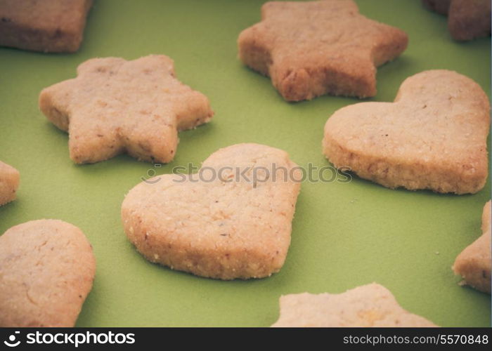 Holiday cookies as a background pattern on green