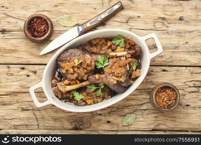 Holiday duck legs baked in apple sauce. Duck legs in a baking dish