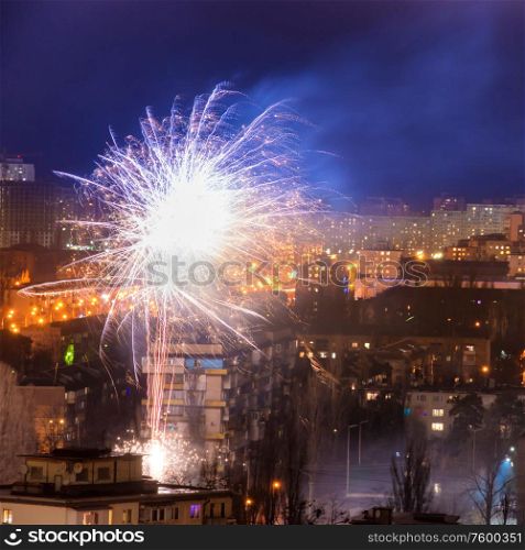 Holiday fireworks in a city with blue night sky