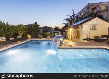 holiday home with swimming pool at dusk