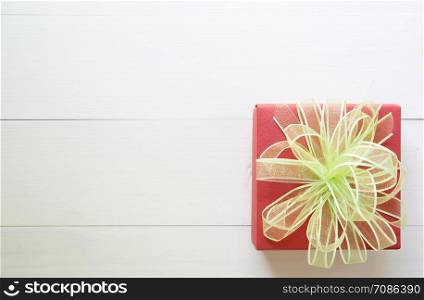 Holiday of gift box with bow ribbon on wooden white table, present of day on wood, top view, vintage retro tone, 14 February of love day with romantic copy space, valentine concept, top view.