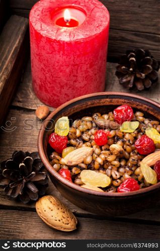 holiday porridge with nuts and raisins. Traditional Christmas porridge, kutya and lighted candle