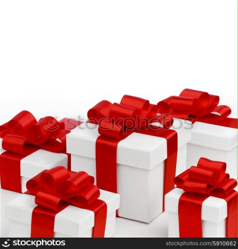 Holiday presents wrapped in white paper with red ribbons, isolated on white