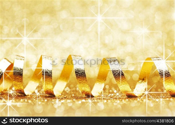 Holiday ribbon on shiny glowing stars gold background