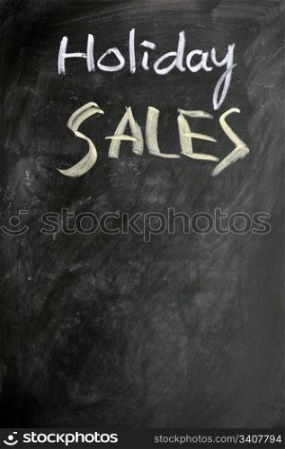 Holiday sales written with chalk on a blackboard