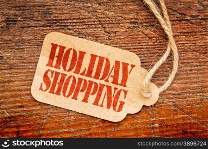 Holiday shopping sign a paper price tag against rustic red painted barn wood