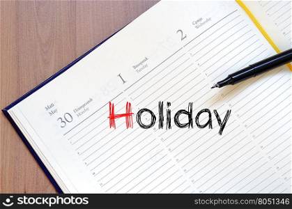 Holiday text concept write on notebook