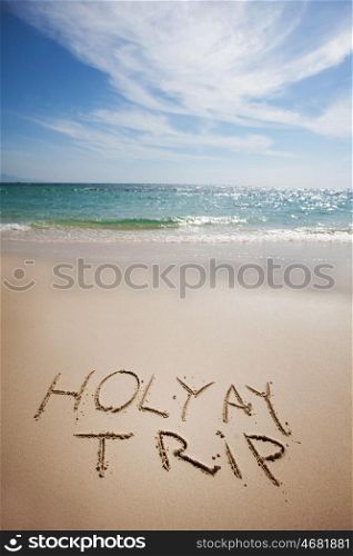 Holiday trip. Holiday trip handwriting on tropical sea beach