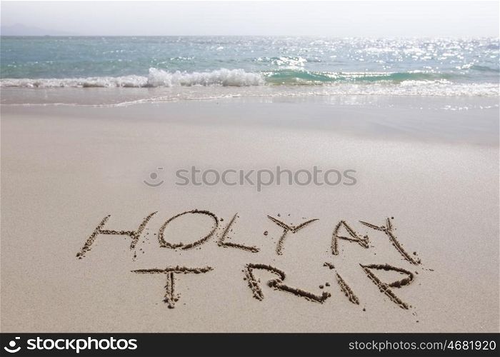 Holiday trip. Holiday trip handwriting on tropical sea beach