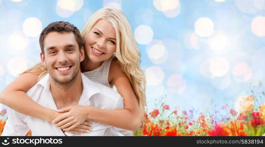 holiday, valentine&#39;s day, dating and love concept - happy couple having fun over blue lights and poppy field background