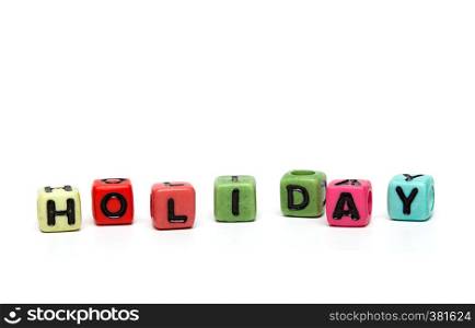 holiday - word made from multicolored child toy cubes with letters