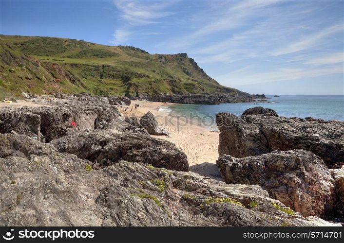 Holidaymakers enjoying the summer sun at Great Mattiscombe Sand, Devon, England.