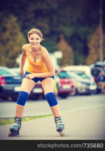 Holidays, active lifestyle freedom concept. Young fit woman on roller skates riding outdoors on street, girl rollerblading on sunny day