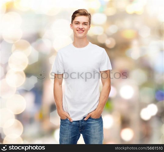 holidays, advertising and people concept - smiling young man in blank white t-shirt over sparkling background
