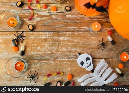 holidays and advertisement concept - halloween decorations and candies with copy space on wooden boards. halloween decorations with space on wooden boards