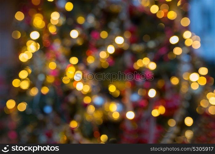 holidays and background concept - fir tree with blurred christmas lights. fir tree with blurred christmas lights background