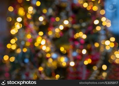 holidays and background concept - fir tree with blurred christmas lights. fir tree with blurred christmas lights background