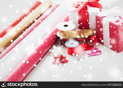 holidays and celebration concept - close up of christmas presents, decoration paper, ribbons and scissors