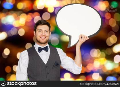 holidays and communication concept - happy man in suit holding blank text bubble banner over festive lights background. man with blank text bubble banner over lights . man with blank text bubble banner over lights