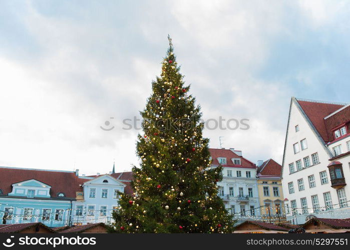 holidays and decoration concept - christmas tree at old town hall square in tallinn. christmas tree at old town hall square in tallinn