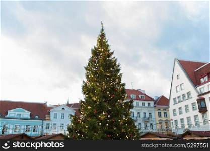 holidays and decoration concept - christmas tree at old town hall square in tallinn. christmas tree at old town hall square in tallinn