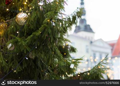 holidays and decoration concept - close up of natural christmas tree at old town hall square in tallinn. close up of christmas tree at old town in tallinn