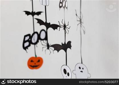 holidays and decoration concept - halloween paper party decorations over white background. halloween party paper decorations