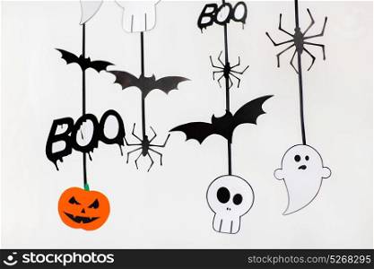 holidays and decoration concept - halloween paper party garlands over white background. halloween party paper garlands or decorations