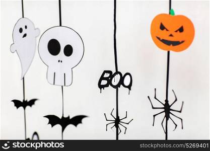 holidays and decoration concept - halloween paper party garlands over white background. halloween party paper garlands or decorations