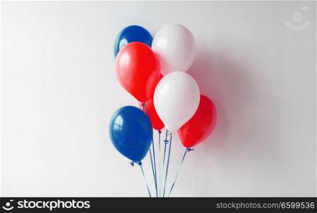 holidays and decorations concept - red, white and blue air balloons for 4th of july or birthday party. party decoration with red, white and blue balloons