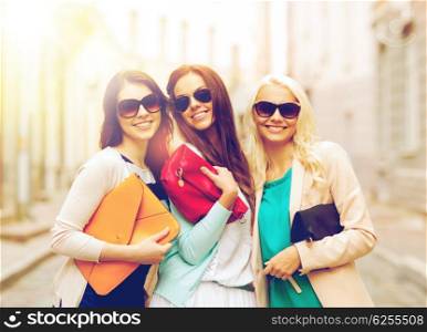 holidays and lifestyle concept - beautiful girls with bags in the ctiy. beautiful girls with bags in the ctiy