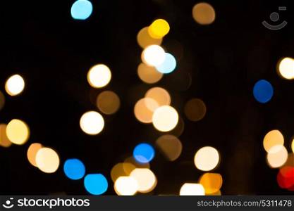 holidays and luxury concept - blurred lights over dark background. blurred golden lights over dark background