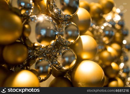 holidays and luxury concept - close up of golden christmas decoration or garland of beads or balls. golden christmas decoration or garland of beads