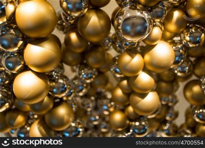 holidays and luxury concept - golden christmas decoration or garland of beads or balls. golden christmas decoration or garland of beads