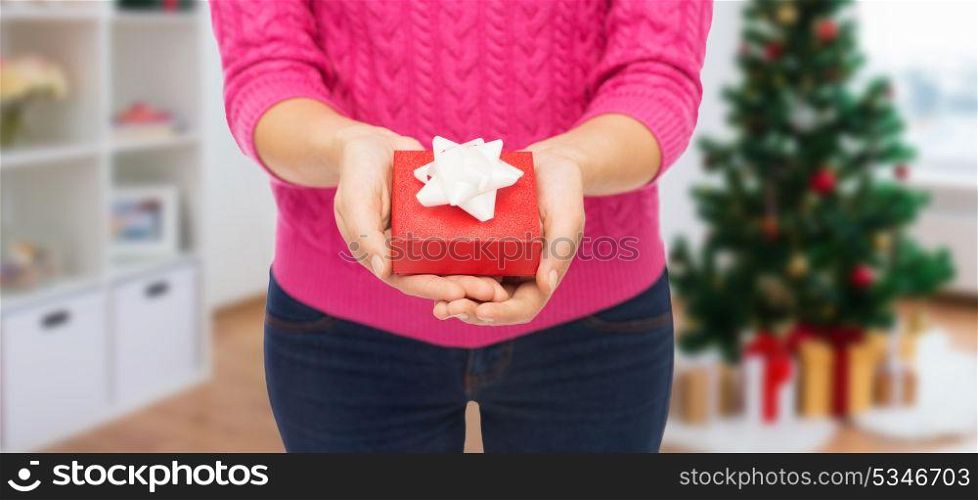 holidays and people concept - close up of woman hands holding christmas gift. close up of woman hands holding christmas gift