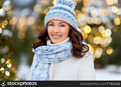 holidays and people concept - happy young woman walking in christmas city in winter. happy woman walking in christmas city in winter