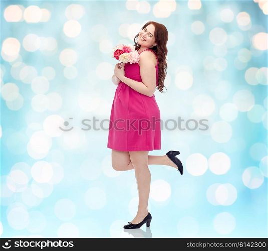 holidays and people concept - smiling happy young plus size woman with flower bunch posing in pink dress background over blue holidays lights background. happy young plus size woman with flower bunch