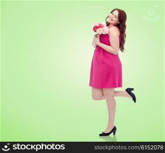 holidays and people concept - smiling happy young plus size woman with flower bunch posing in pink dress over green natural background. happy young plus size woman with flower bunch