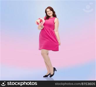 holidays and people concept - smiling happy young plus size woman with flower bunch posing in pink dress over rose quartz and serenity gradient background. happy young plus size woman with flower bunch