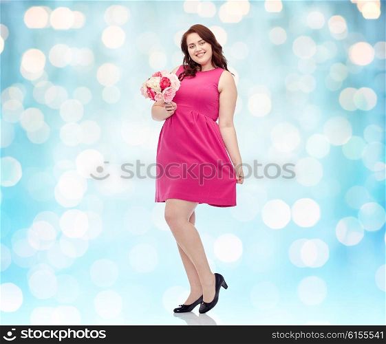 holidays and people concept - smiling happy young plus size woman with flower bunch posing in pink dress over blue holidays lights background. happy young plus size woman with flower bunch