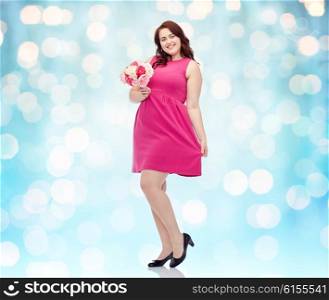 holidays and people concept - smiling happy young plus size woman with flower bunch posing in pink dress over blue holidays lights background. happy young plus size woman with flower bunch