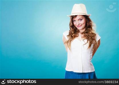 Holidays and summer fashion. Girl in fashionable clothes straw hat. Portrait of charming woman tourist on blue