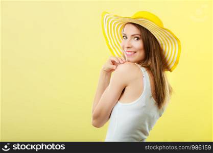 Holidays and summer fashion. Woman in big yellow hat. Portrait of charming female on bright background.