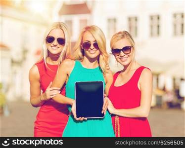 holidays and tourism concept - beautiful blonde girls toursits showing tablet pc with blank screen in the city. beautiful tourist girls holding tablet pc
