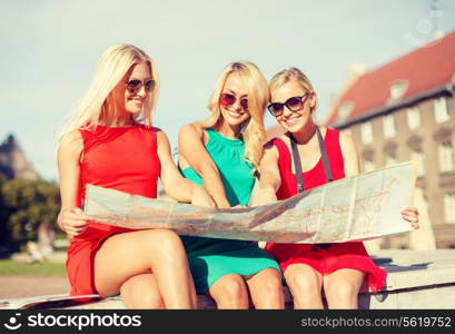 holidays and tourism concept - beautiful blonde women with tourist map in the city