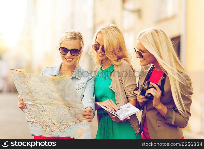 holidays and tourism concept - beautiful blonde women with tourist map in the city. beautiful women with tourist map in the city