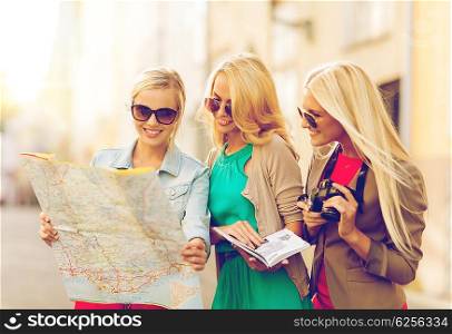 holidays and tourism concept - beautiful blonde women with tourist map in the city. beautiful women with tourist map in the city